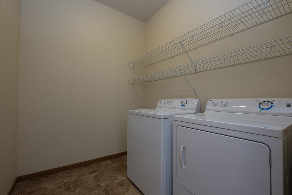 a laundry room with a washer and dryer. Fargo, ND North Sky Apartments