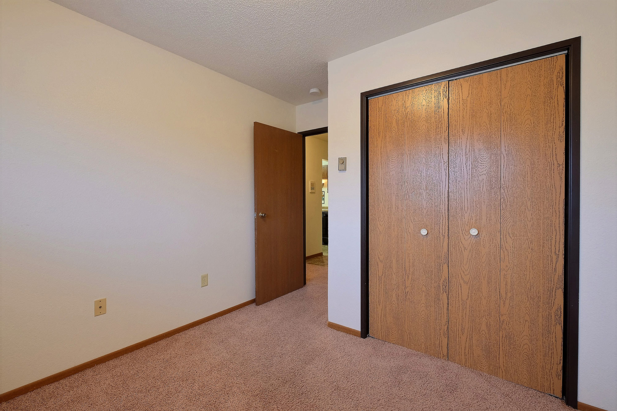 a bedroom with a closet. Fargo, ND Village West Apartments