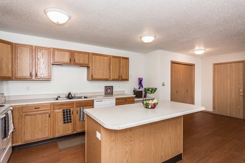 a kitchen with wooden cabinets and a white counter top