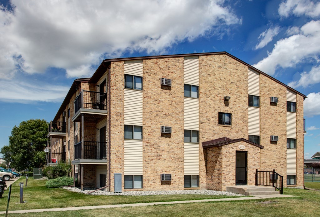 the exterior of a three level apartment. Fargo, ND Westwood Apartments