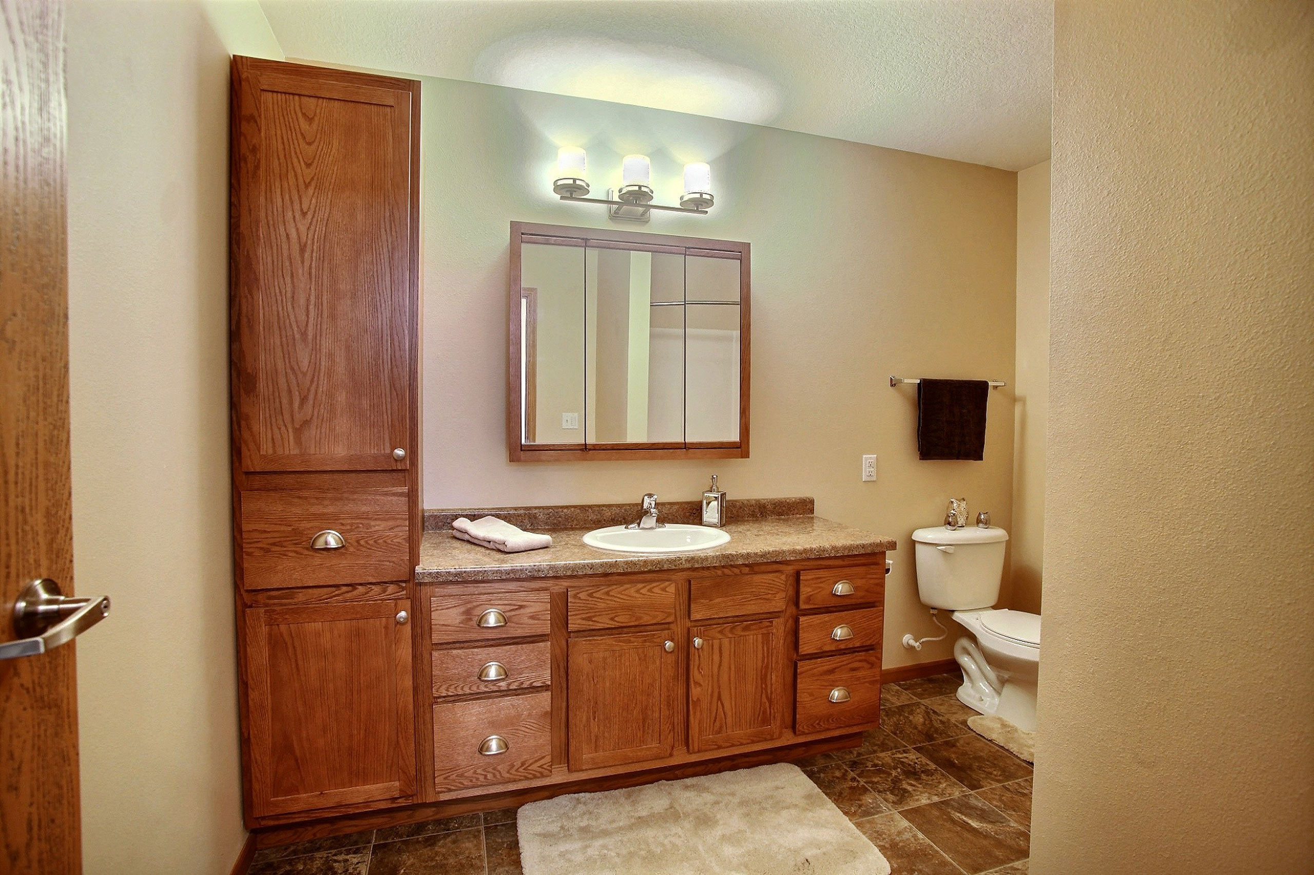 a bathroom with a sink and a toilet and a shower. Fargo, ND Wolf Creek Apartments