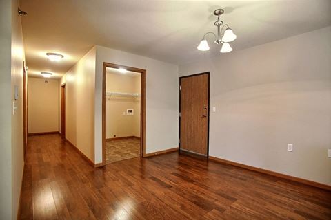 a dining room with a door and laundry room. Fargo, ND Wolf Creek Apartments