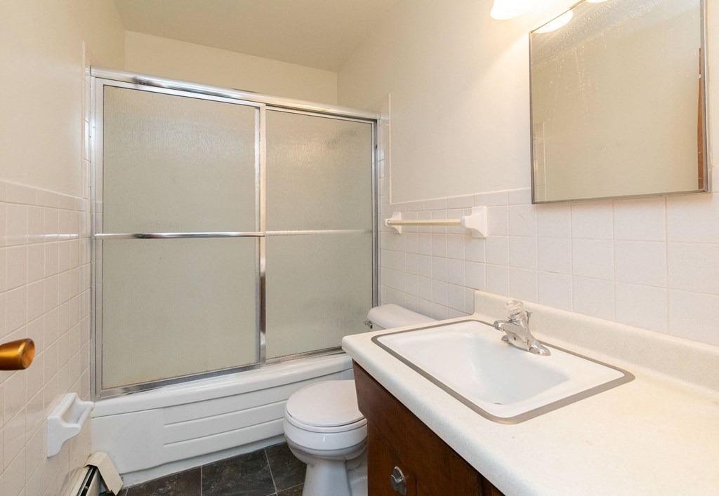 a bathroom with a sink toilet and shower. Fargo, ND Islander Apartments
