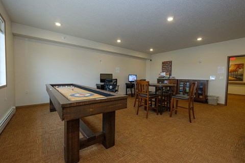 a community room with games and tables. Fargo, ND North Sky Apartments