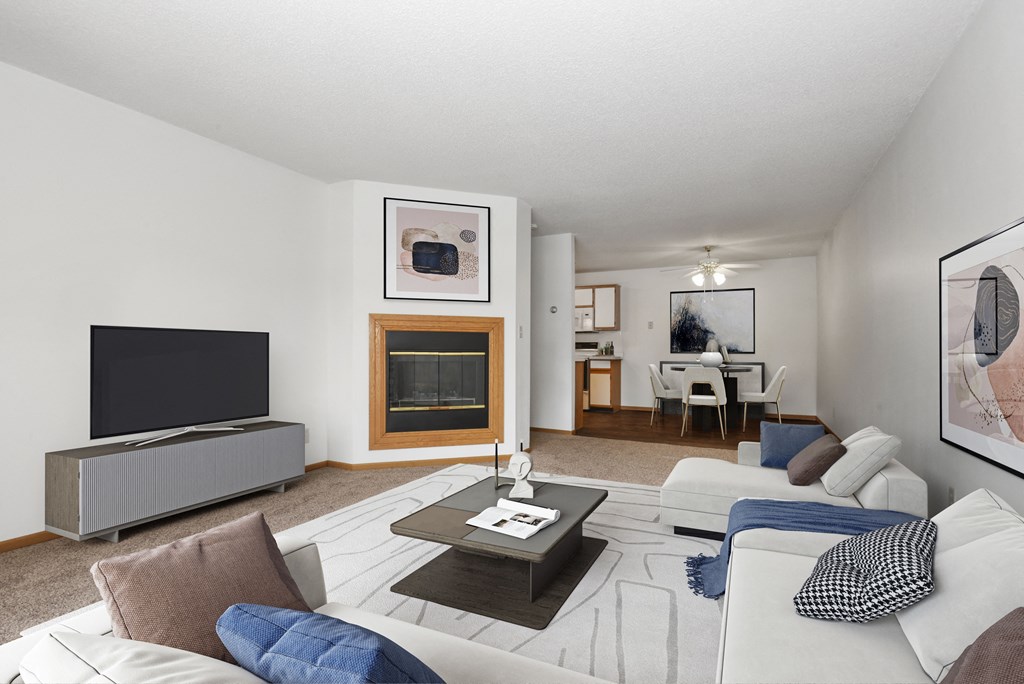 a living room with couches and a tv and a fireplace. Anoka, MN Dellwood Estates Apartments