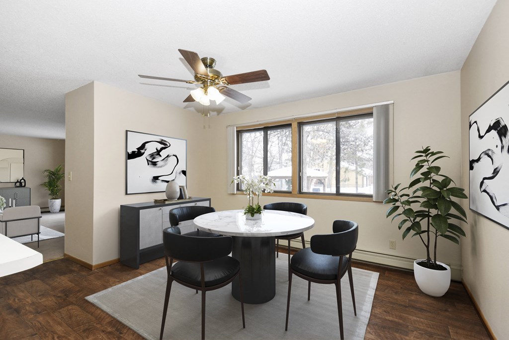 a dining room with a table and chairs and a ceiling fan. Anoka, MN Dellwood Estates