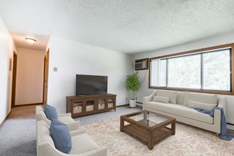 Bismarck, ND Arbor 400 a living room with white couches and chairs and a large window