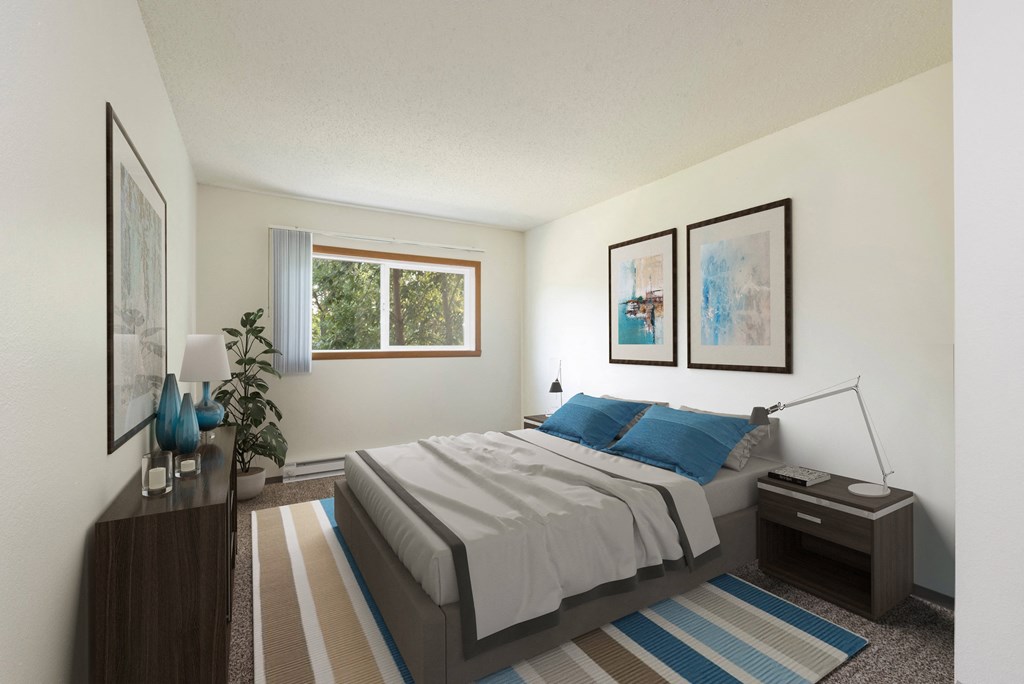 Bismarck, ND Bradbury Apartments | Bedroom Bismarck, ND Bradbury Apartments. a bedroom with blue accents. The large window brightens the interior with natural light. The bed, dresser, and wall art make for a comforting appearance.