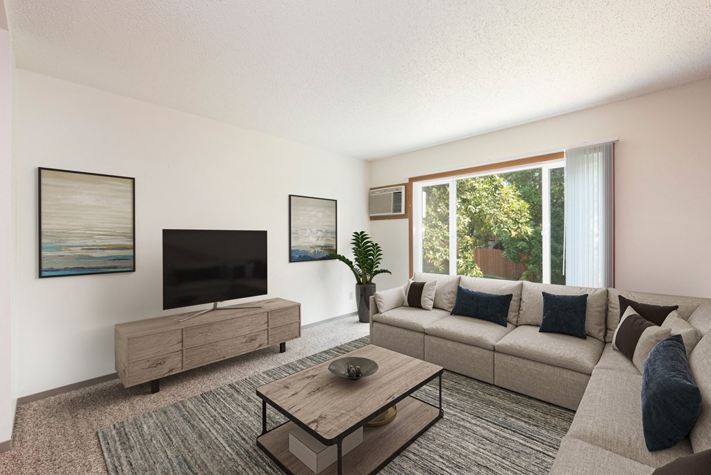 Bismarck, ND Bradbury Apartments. a living room with a couch and coffee table and a large window
