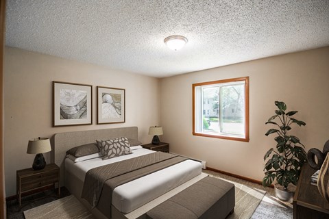 a bedroom with a bed and a window. Bismarck, ND Eastbrook Apartments.