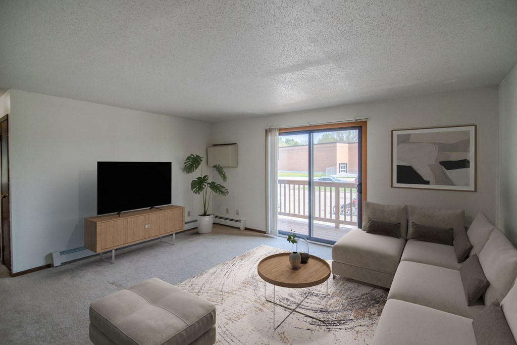 Bismarck, ND Eastbrook Apartments | Living A living room with a couch and a coffee table. Bismarck, ND Eastbrook Apartments.