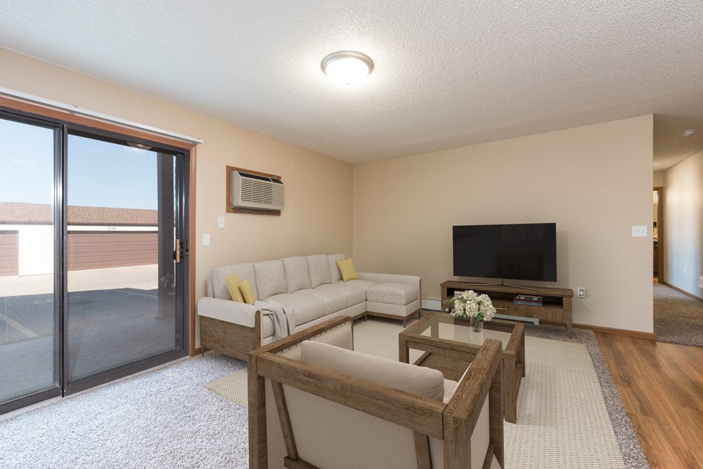 Bismarck, ND Fairview. a living room with a tv and a sliding glass door