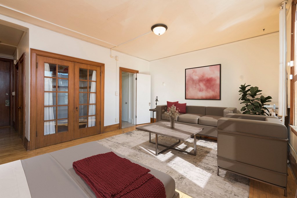 Bismarck, ND Mason Apartment. a studio apartment with a living room with a couch and a coffee table and a bed