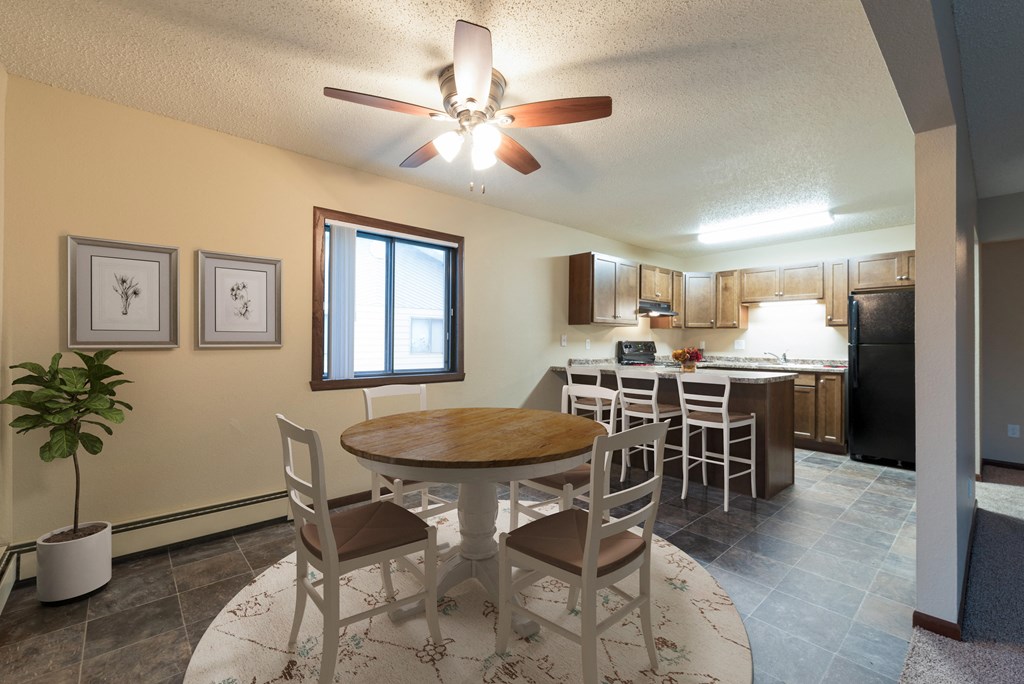 Bismarck, ND Newgate Apartments | Dining a dining room with a table and chairs. Bismarck, ND Newgate Apartments