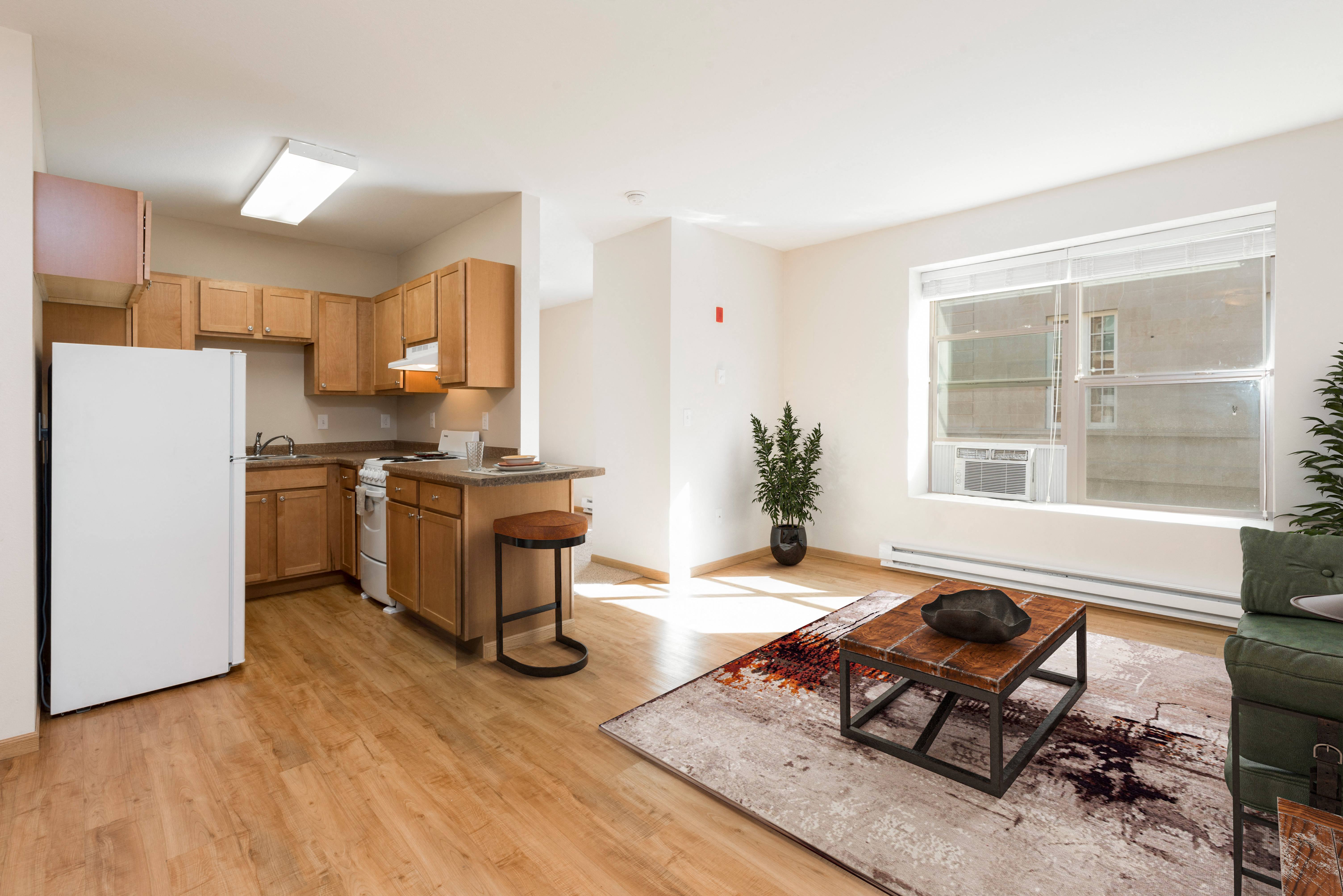 Bismarck, ND Norma apartment. The space features a comfortable living area and a separate sleeping room. The living area is designed with simplicity and functionality, while the sleeping room provides privacy and tranquility. It's a comfortable and inviting living space with natural light from the large window