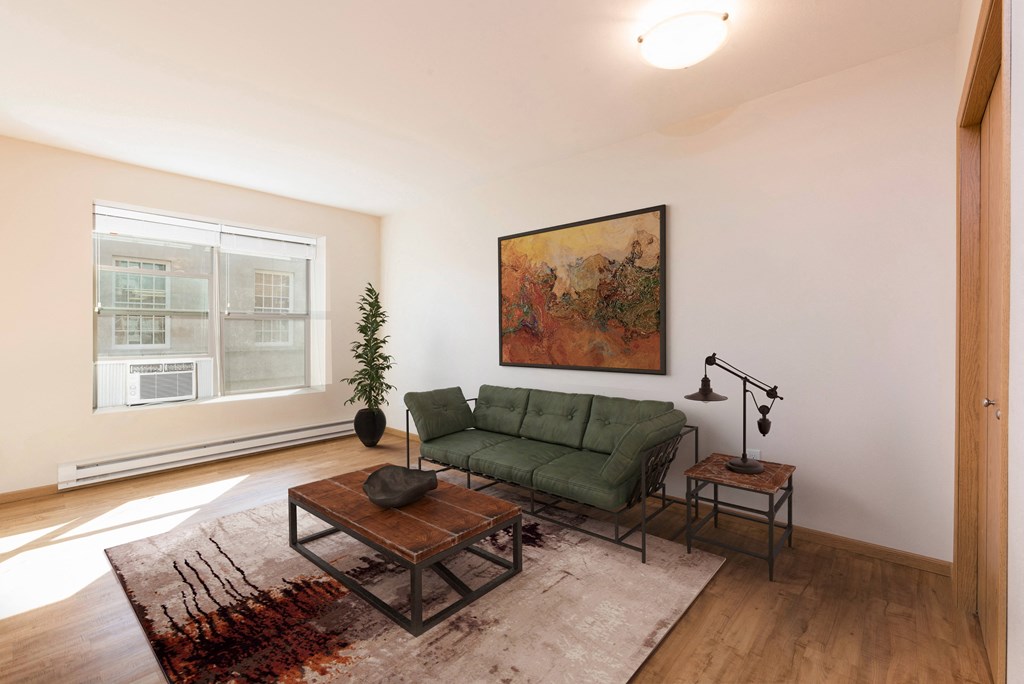 Bismarck, ND Norma apartment. The space features a comfortable living area and a separate sleeping room. The living area is designed with simplicity and functionality, while the sleeping room provides privacy and tranquility. It's a comfortable and inviting living space with natural light from the large window