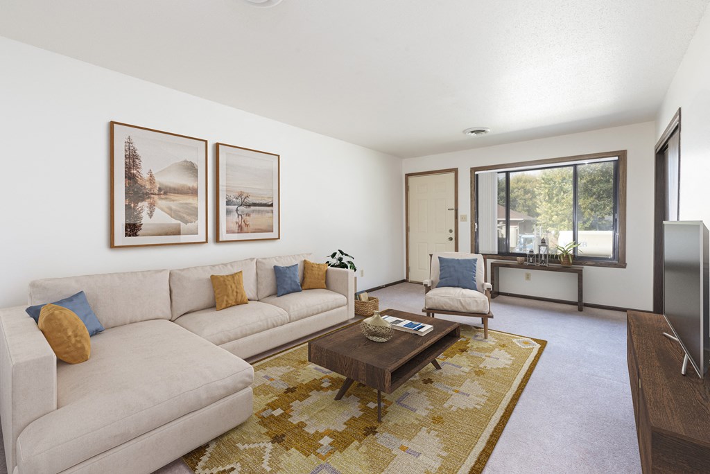 Bismarck, ND Riverpark Apartments The room features large windows that offer scenic views of the surrounding area, comfortable seating, and modern decor. The dark wood trim and furnishings bring the room to life with highly contrasting colors