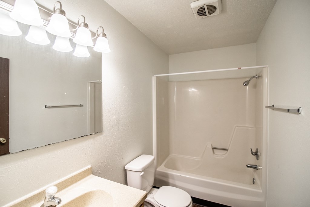 Bismarck, ND Rosser Apartments. a bathroom with a bathtub and a sink