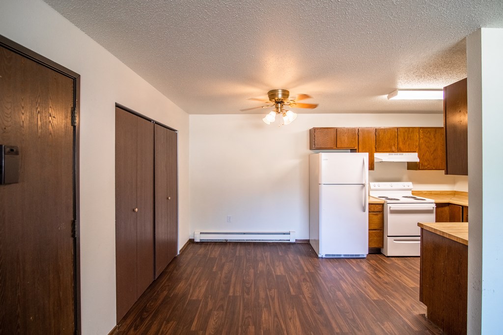 Bismarck, ND Rosser Apartments. a dining room with a closet and ceiling fan