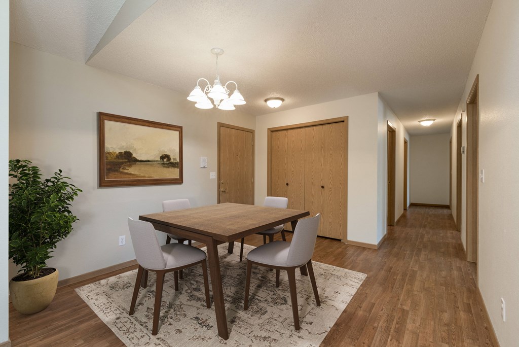Sierra Ridge Apartments in Bismarck, ND | Dining Room Bismarck, ND Sierra Ridge Apartments. The room showcases a modern dining table with four elegant chairs, well-placed lighting, and a sophisticated ambiance for enjoyable meals and gatherings.