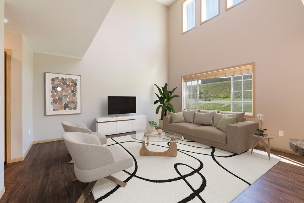 Bismarck, ND Stonefield Townhomes | Living Room Bismarck, ND Stonefield Townhomes. The large room showcases comfortable seating, modern decor, and natural lighting, creating a welcoming and relaxing space for residents.