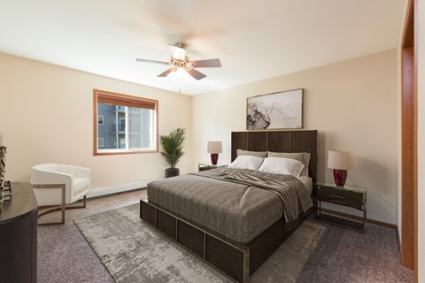 Bismarck, ND Stonefield Apartments | Bedroom Bismarck, ND Stonefield Apartments. A bedroom with a bed and a ceiling fan