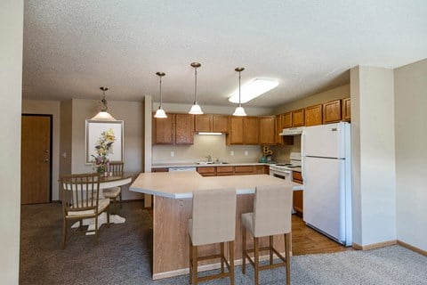 Kitchen with Wood Cabinetry at Sunset Ridge Apartments in Bismarck, ND
