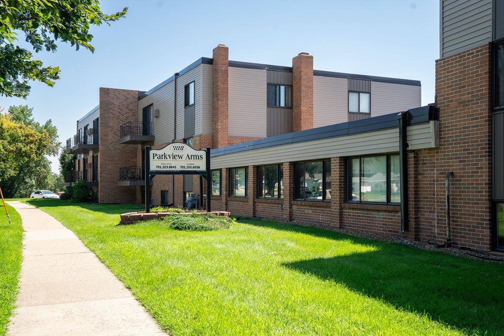 The image shows a building with the name  Bismarck, ND Parkview Arms Apartments