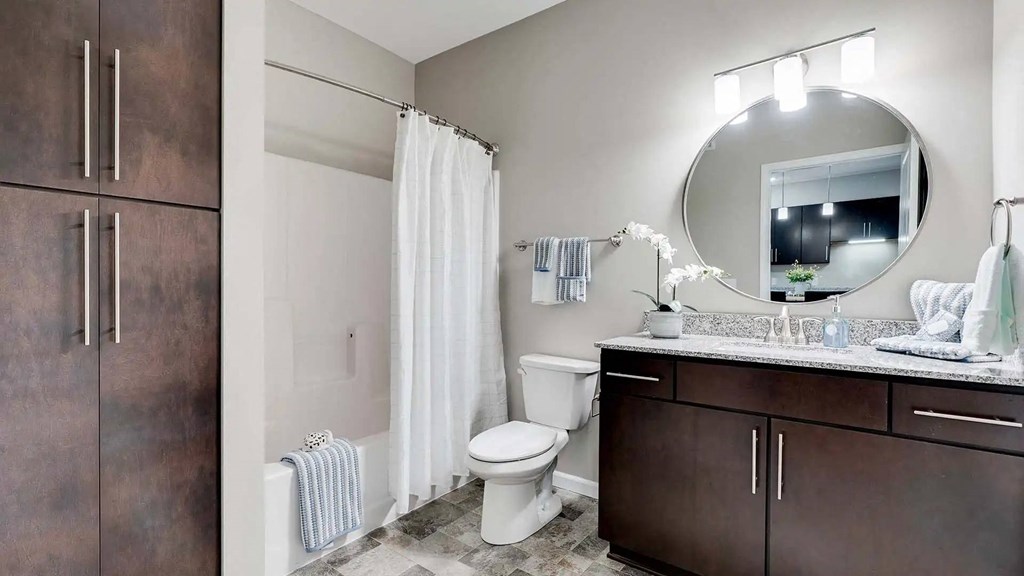 a bathroom with a white toilet and a sink. Circle Pines, MN Lexington Lofts