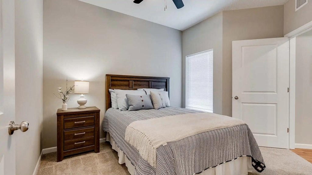 a bedroom with a bed and a closet. Circle Pines, MN Lexington Lofts