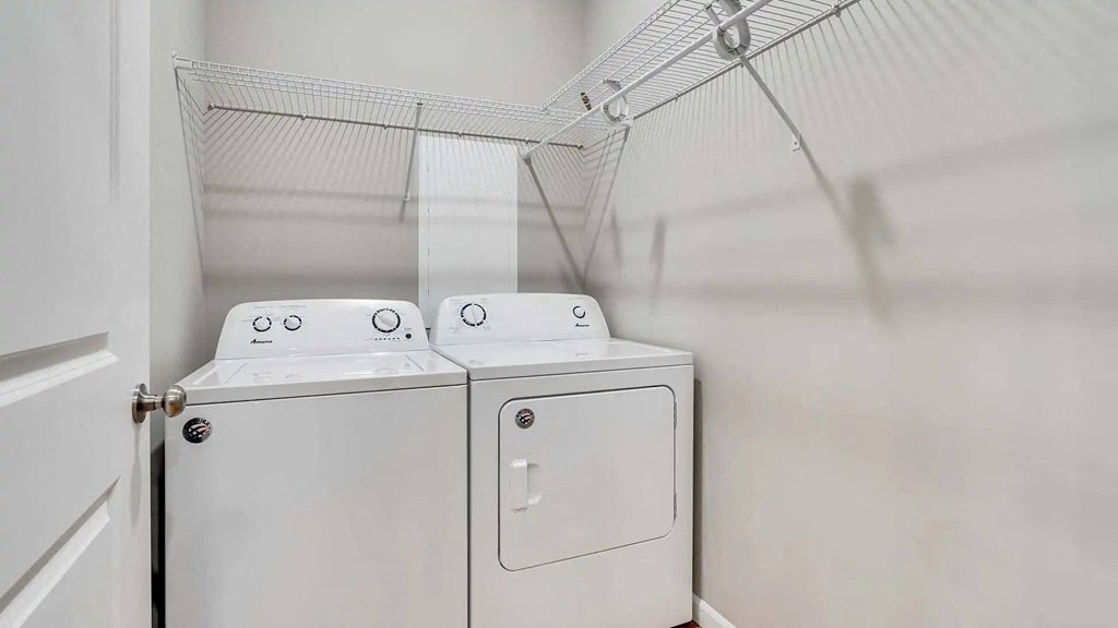 a washer and dryer in a laundry room with white walls. Circle Pines, MN Lexington Lofts