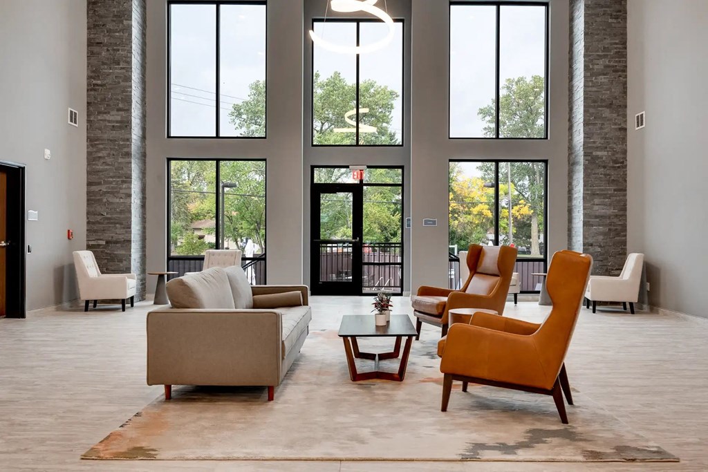 a living room with couches chairs and a table. Circle Pines, MN Lexington Lofts