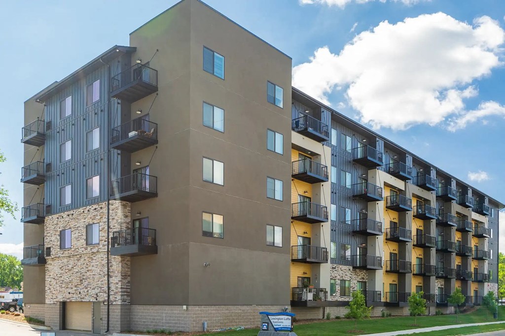 an image of an apartment building on a cloudy day. Circle Pines, MN Lexington Lofts