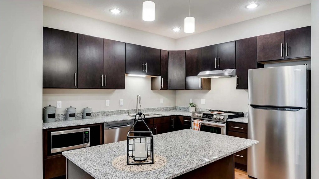 a kitchen with stainless steel appliances and granite counter tops. Circle Pines, MN Lexington Lofts