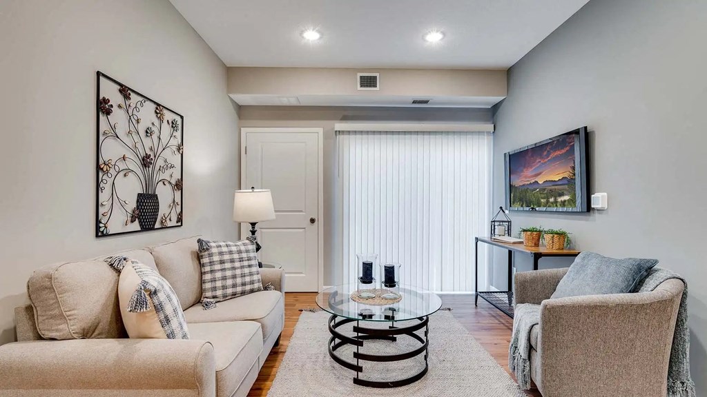 a living room with two couches and a glass coffee table. Circle Pines, MN Lexington Lofts