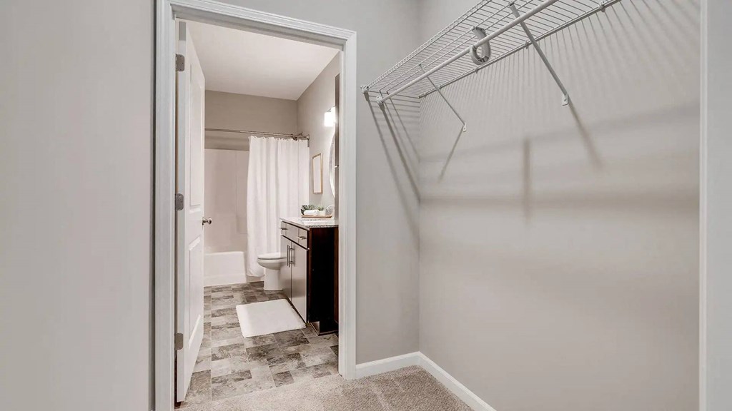 a bathroom with a shower and a sink and a toilet. Circle Pines, MN Lexington Lofts