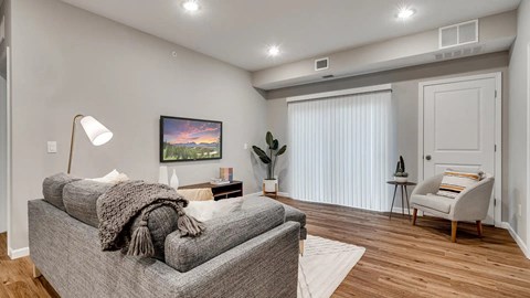 a living room with a couch and a chair. Circle Pines, MN Lexington Lofts