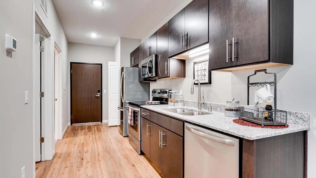 a kitchen with a counter top and a sink. Circle Pines, MN Lexington Lofts
