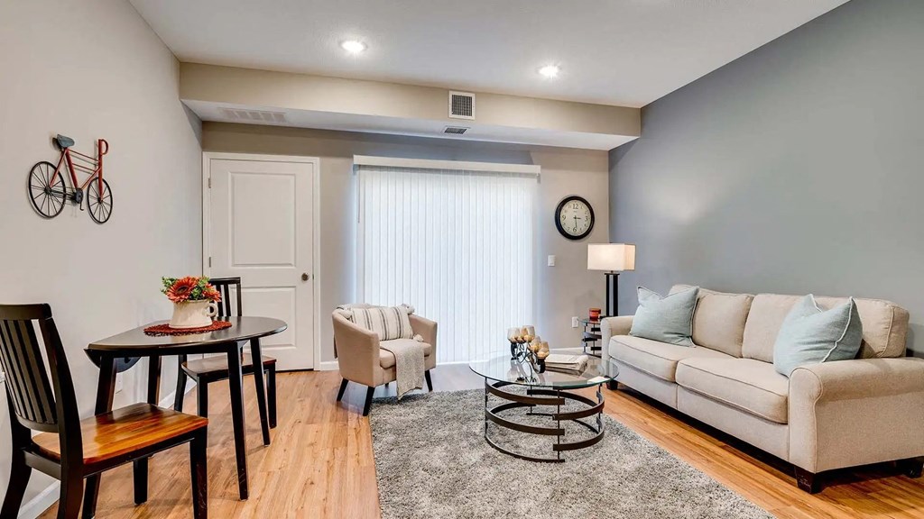 a living room with a couch and a table. Circle Pines, MN Lexington Lofts