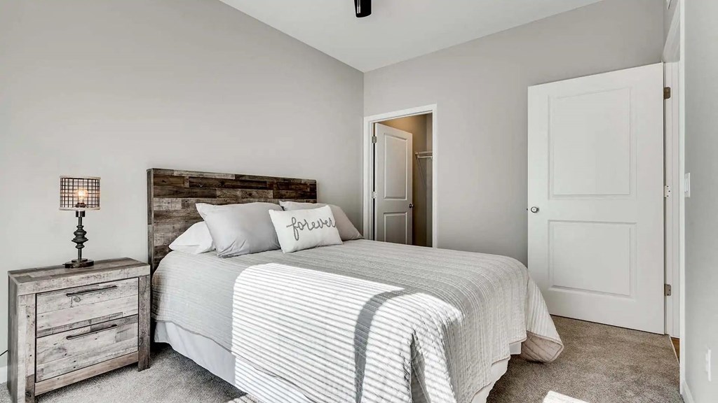 a bedroom with a bed and a closet. Circle Pines, MN Lexington Lofts