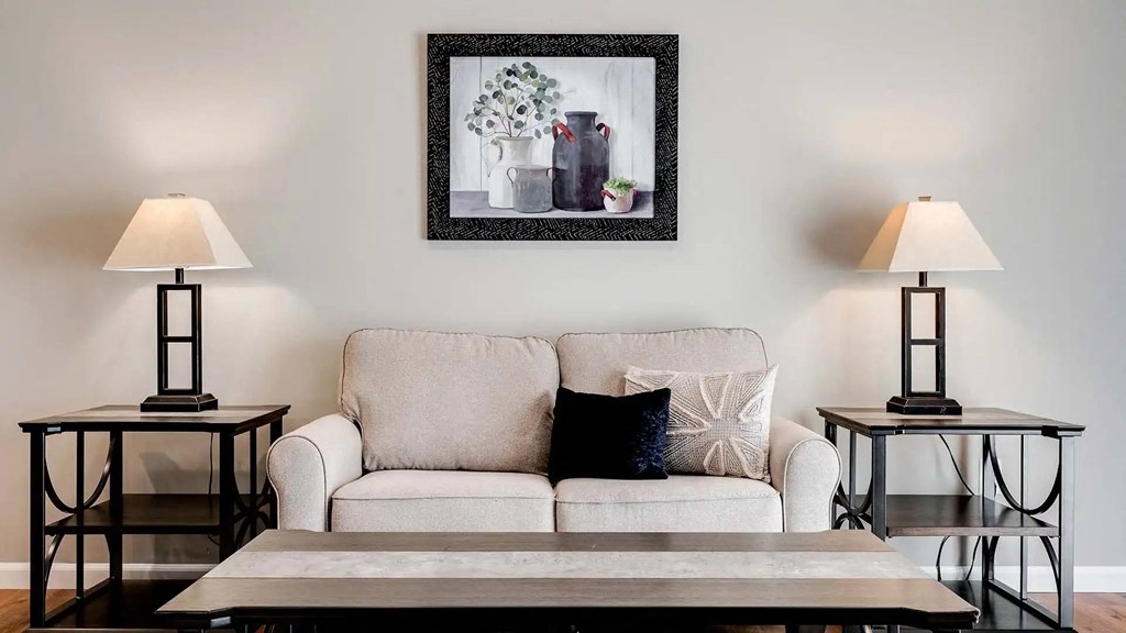 a living room with a couch and a table with lamps. Circle Pines, MN Lexington Lofts