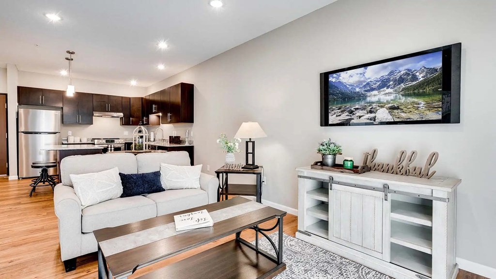 a living room and kitchen with a couch and a table. Circle Pines, MN Lexington Lofts