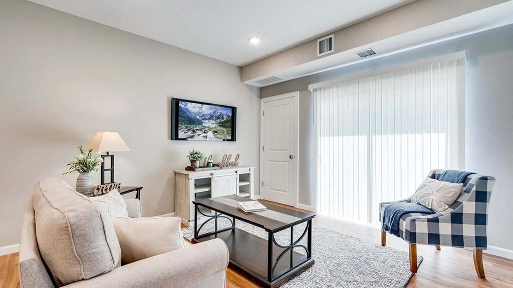 a living room with a couch and a chair. Circle Pines, MN Lexington Lofts
