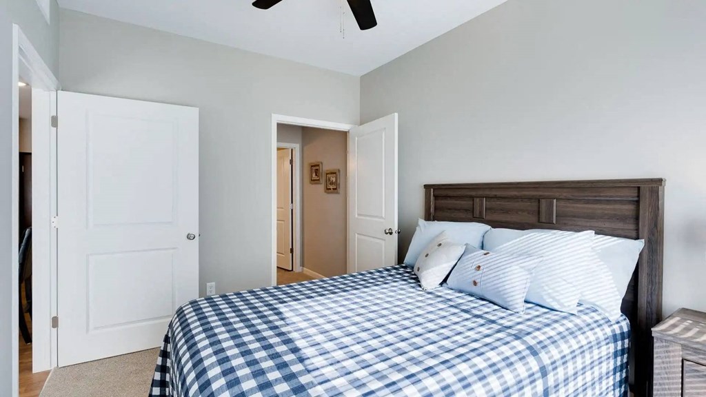 a bedroom with a bed and a closet. Circle Pines, MN Lexington Lofts