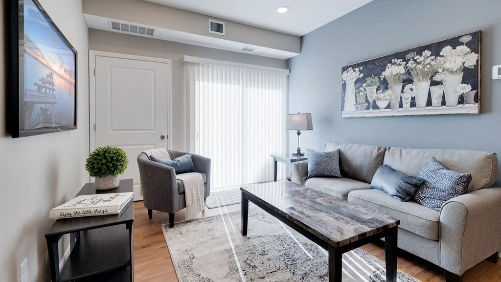 a living room with a couch and a table. Circle Pines, MN Lexington Lofts