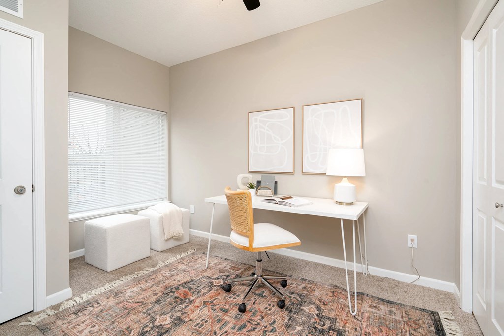 a home office with a desk and a window. Circle Pines, MN Lexington Lofts