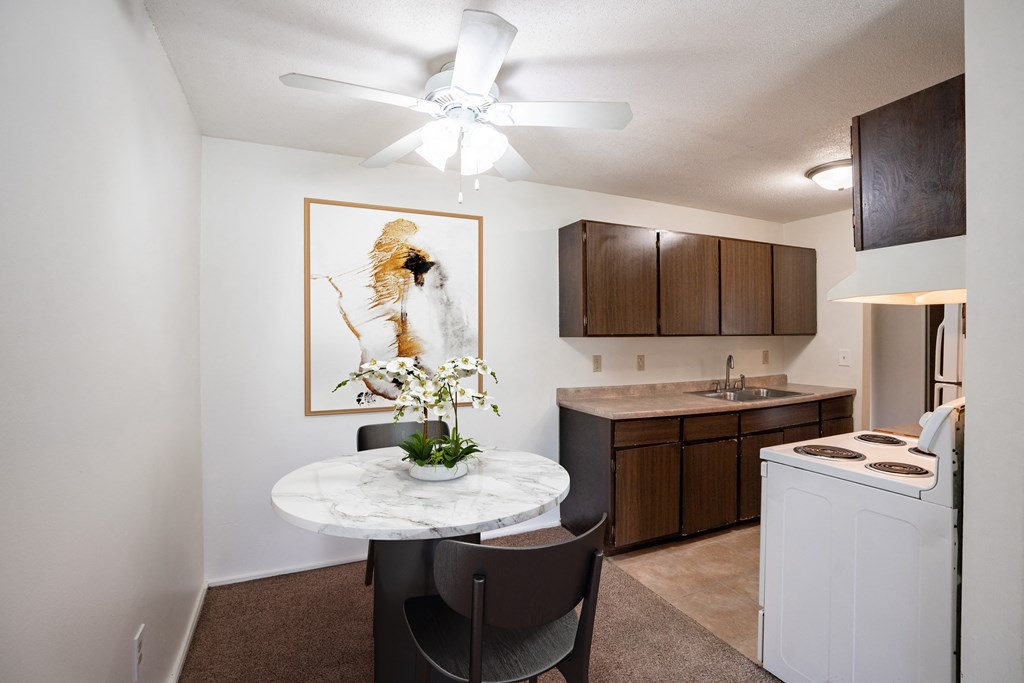 our apartments offer a kitchen and living room with a round table. Coon Rapids, MN Robinwood Apartment