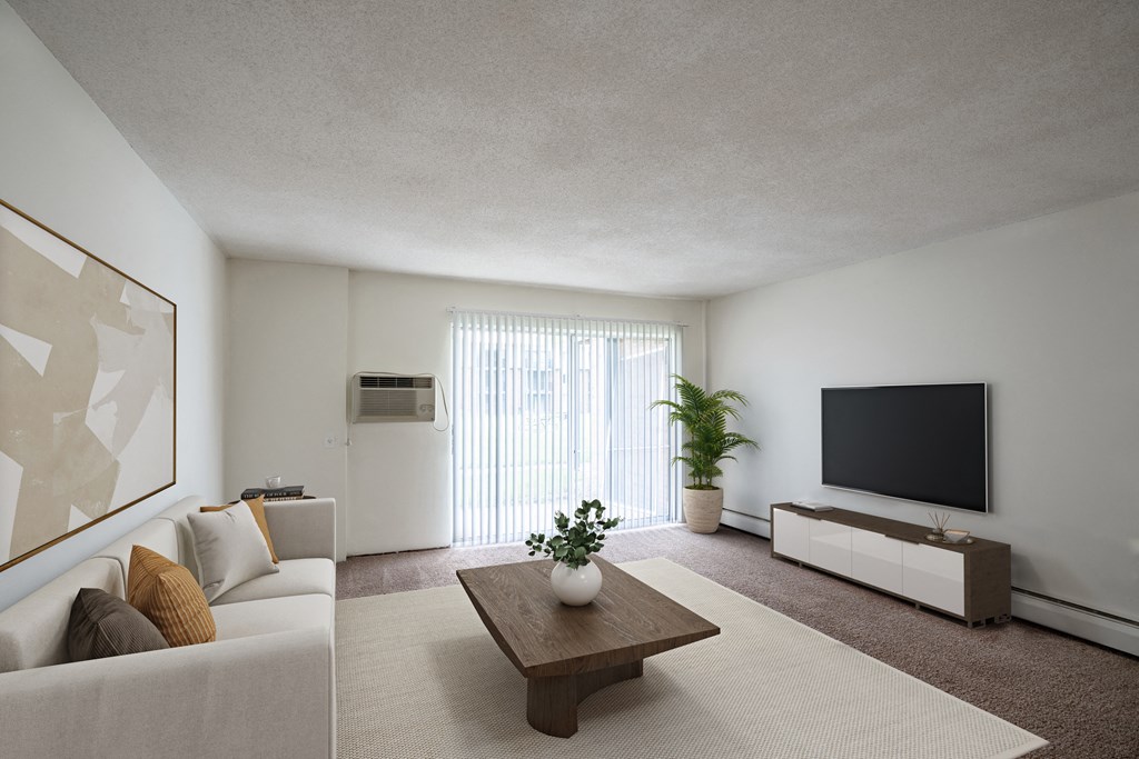 a living room with a couch and a coffee table. Coon Rapids, MN Robinwood Apartments