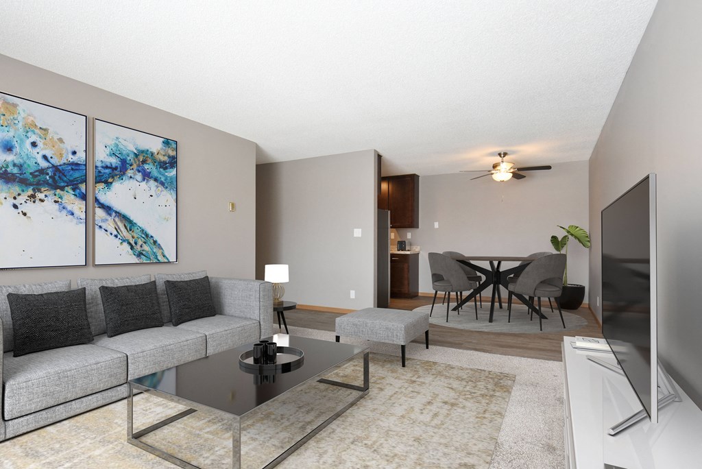 A cozy and inviting living room in Eagan Glen Pond 11A. The room is tastefully furnished with a comfortable sofa, armchair, and coffee table