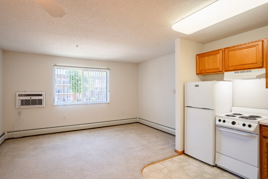 an empty kitchen with white appliances and a window.  Eagan, MN Glen Pond Apartments